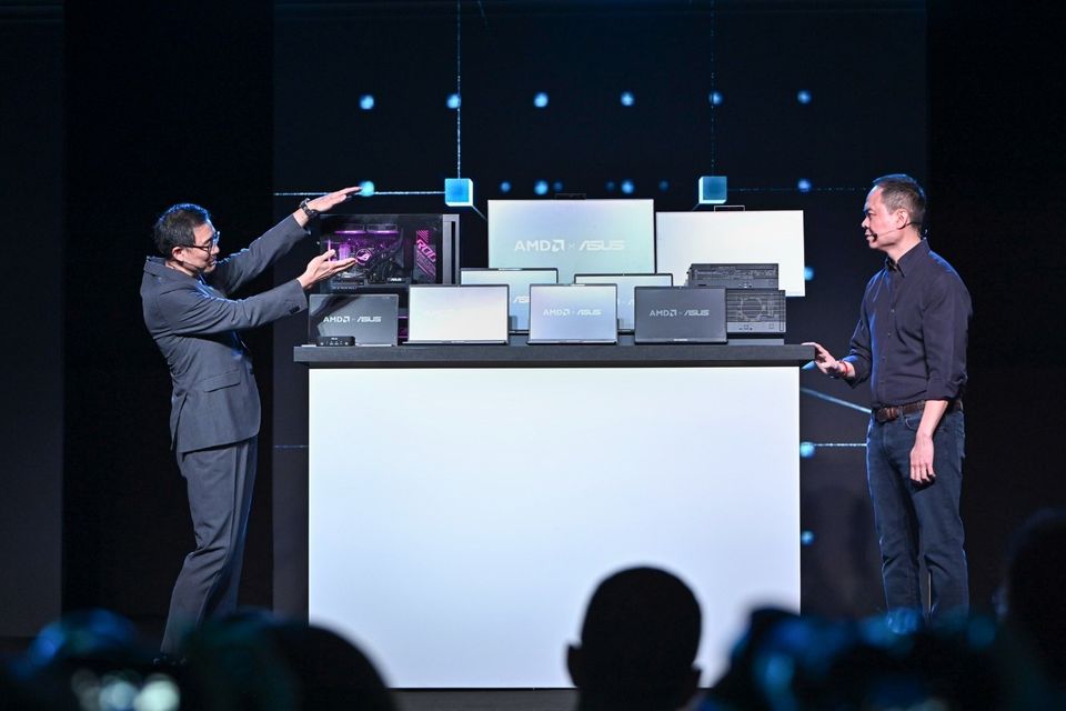 ASUS Co-CEO S.Y. Hsu (left) shows Jack Huynh, AMD Senior Vice President and General Manager of the Computing and Graphics Group, some of ASUS's commercial products at the AMD press conference during Computex.